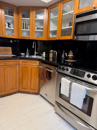 a kitchen with stainless steel appliances granite countertop a stove and a microwave