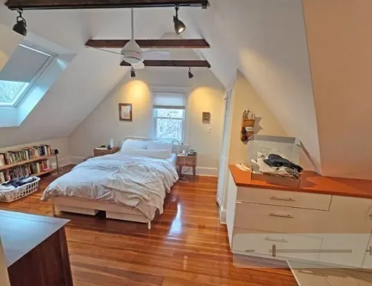 a bedroom with bed and window