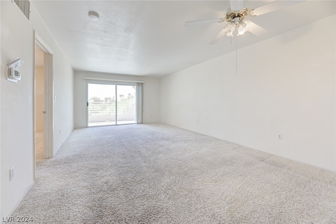 1908 Rio Canyon Court, Unit 202 Las Vegas, NV 89128 - Photo 4 of 29 LIVING ROOM WITH SLIDER TO BALCONY