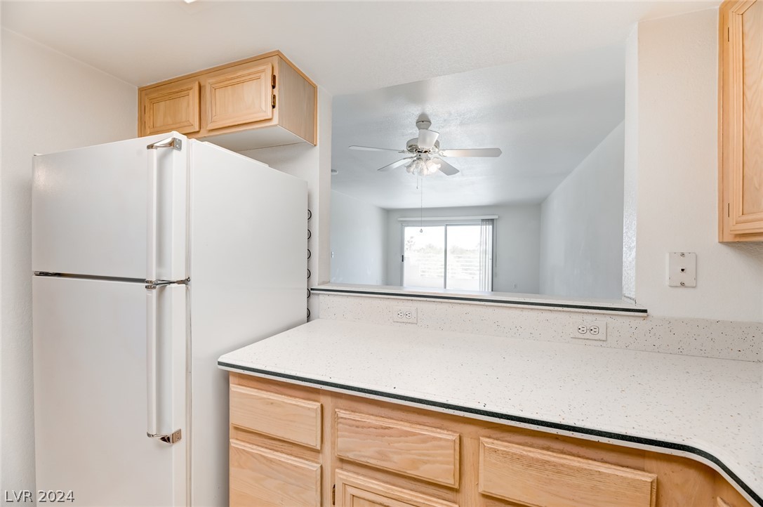 1908 Rio Canyon Court, Unit 202 Las Vegas, NV 89128 - Photo 7 of 29 KITCHEN WITH PASS THOUGH TO DINING AREA OF LIVING