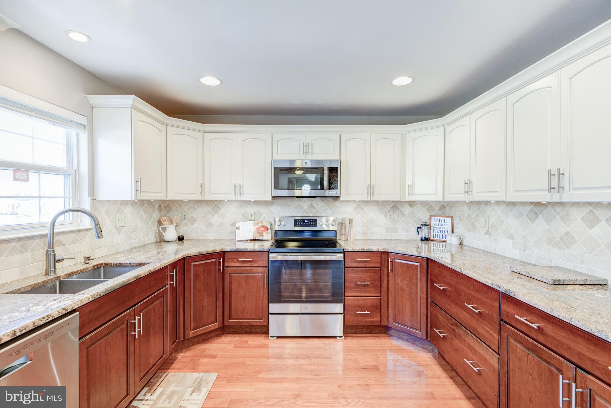 21 Oakview Drive Newark, DE 19702 - Photo 26 of 65 a kitchen with stainless steel appliances granite countertop a sink stove and cabinets