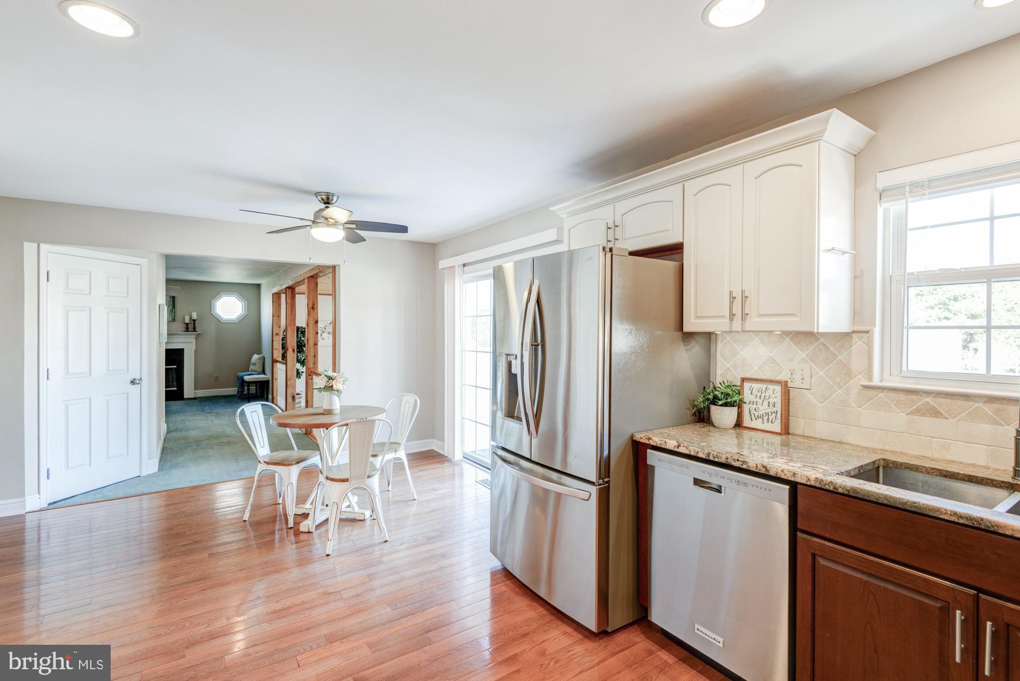 21 Oakview Drive Newark, DE 19702 - Photo 27 of 65 a kitchen with kitchen island white cabinets and stainless steel appliances