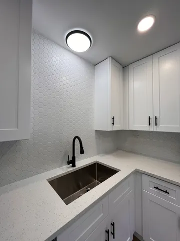 a kitchen with a sink and cabinets