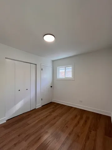 a view of a room with wooden floor and white walls