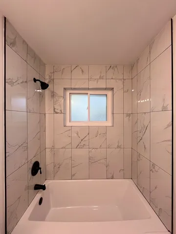 a bathroom with a bathtub and a shower