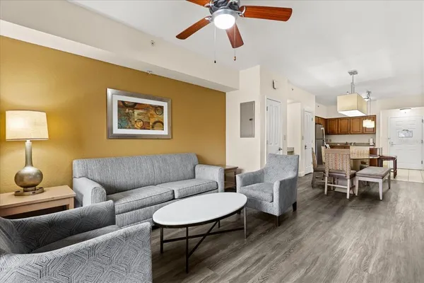 a kitchen with stainless steel appliances granite countertop a refrigerator a stove a sink a dining table and chairs