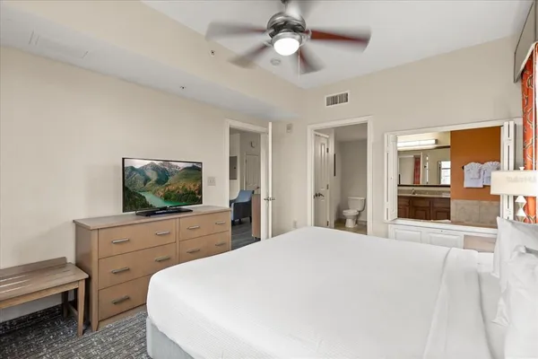 a bedroom with two beds and painting on the wall