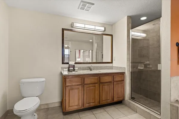 a bedroom with two beds and a chandelier