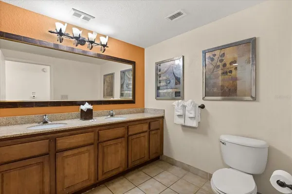 a bathroom with a toilet a sink and a mirror