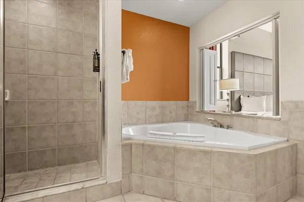 a bedroom with two beds and a lamp