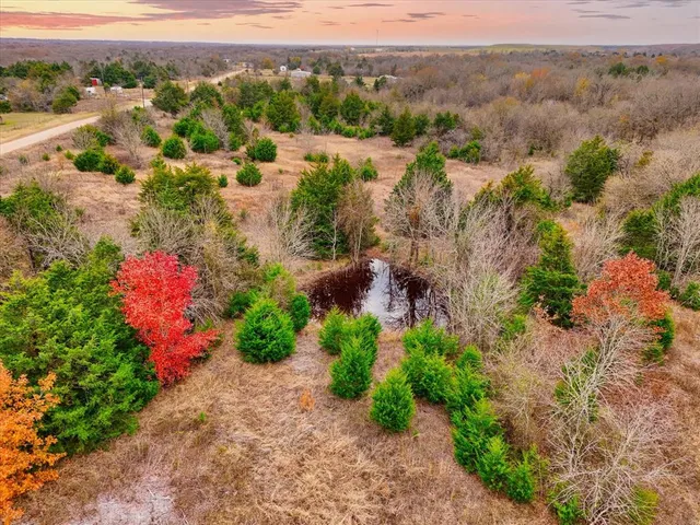an aerial view of mountain with residential house and green space