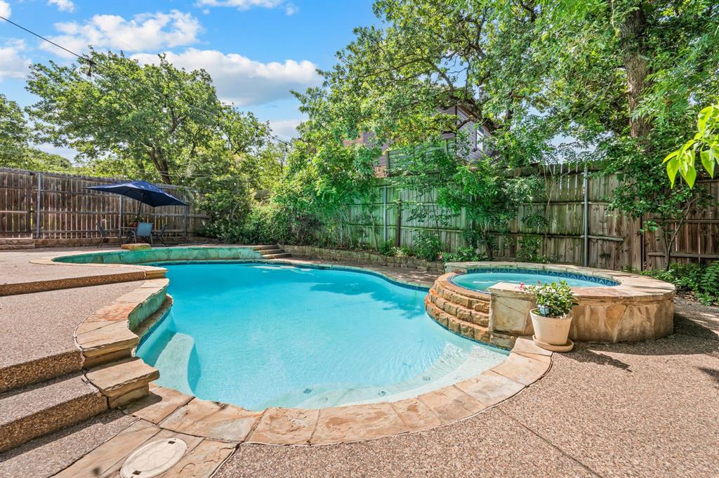 808 Briar Ridge Drive Keller, TX 76248 - Photo 35 of 40 Outdoor living area featuring a freeform swimming pool, integrated spa with stone surround, and extensive concrete decking