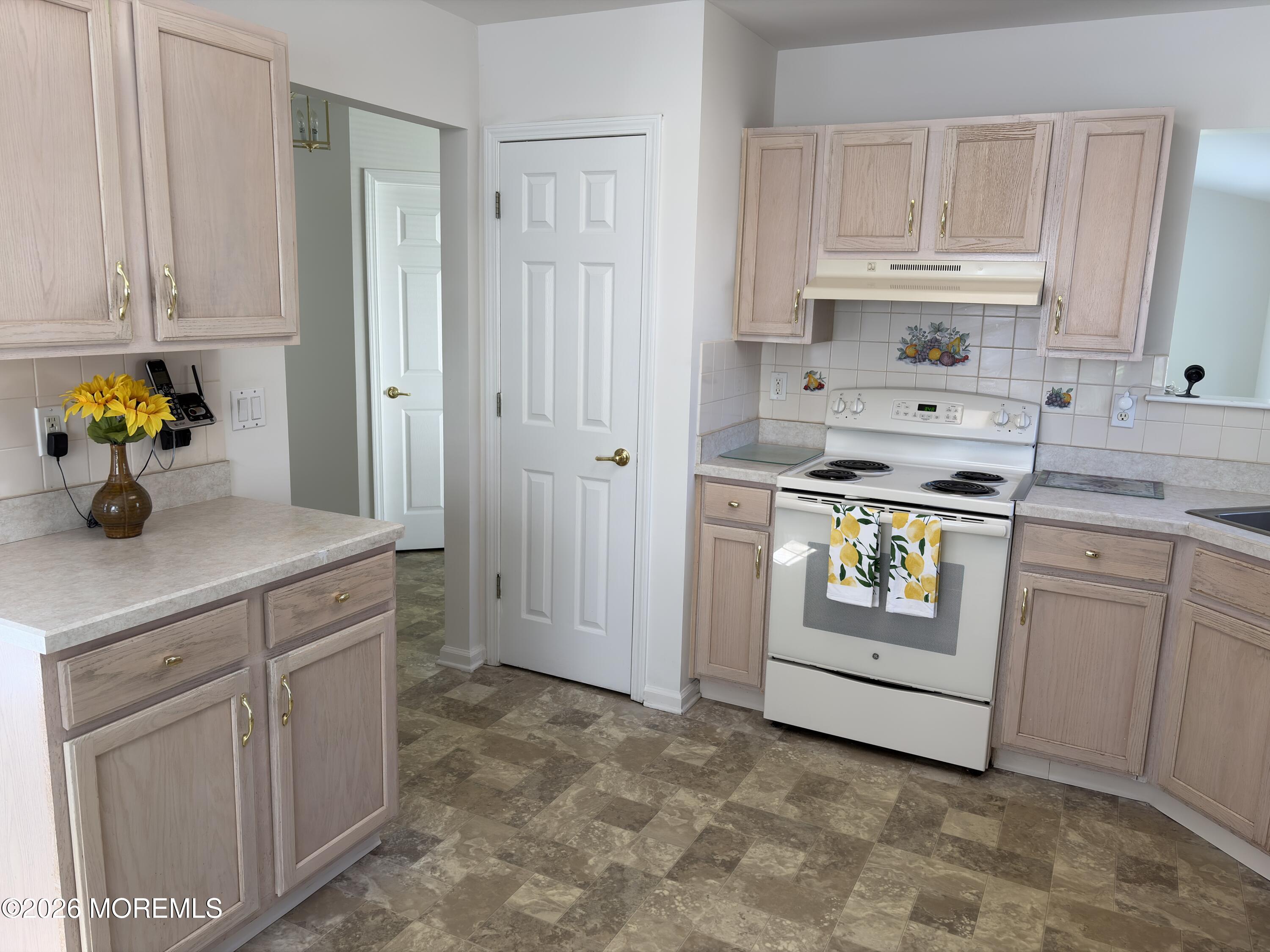 35 Meadows Lane Whiting, NJ 08759 - Photo 7 of 23 a kitchen with stainless steel appliances a stove a white cabinets and a sink
