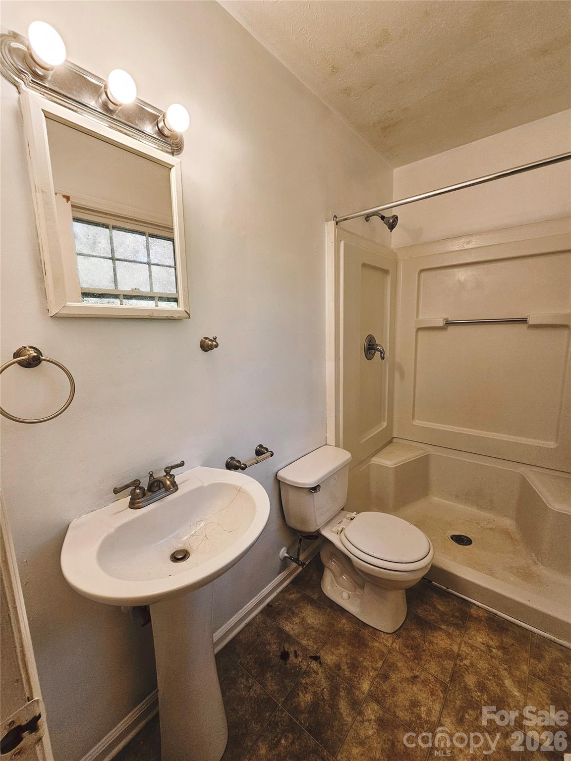 468 Beaverdam Road Asheville, NC 28804 - Photo 19 of 19 a bathroom with a sink toilet a mirror and shower