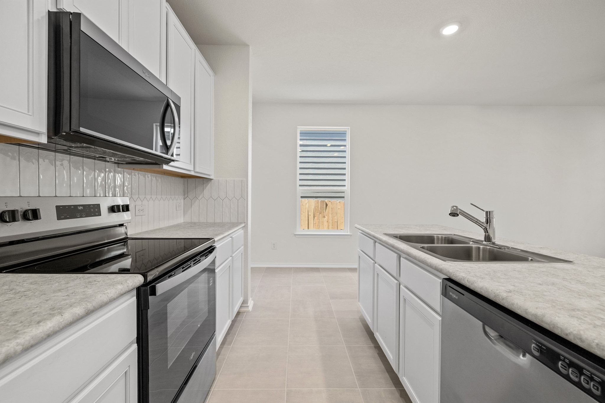 248 Feathers Street Jarrell, TX 76537 - Photo 11 of 32 a kitchen with a sink and steel appliances