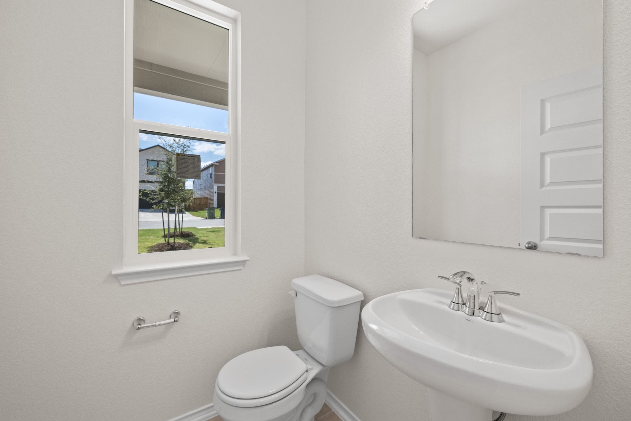 248 Feathers Street Jarrell, TX 76537 - Photo 14 of 32 a bathroom with a sink a toilet and a mirror