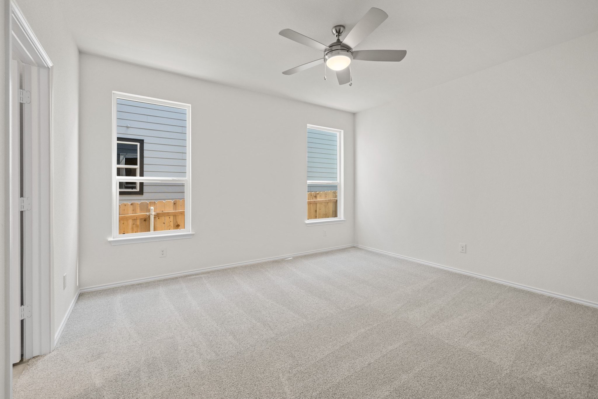 248 Feathers Street Jarrell, TX 76537 - Photo 15 of 32 an empty room with a window and a ceiling fan