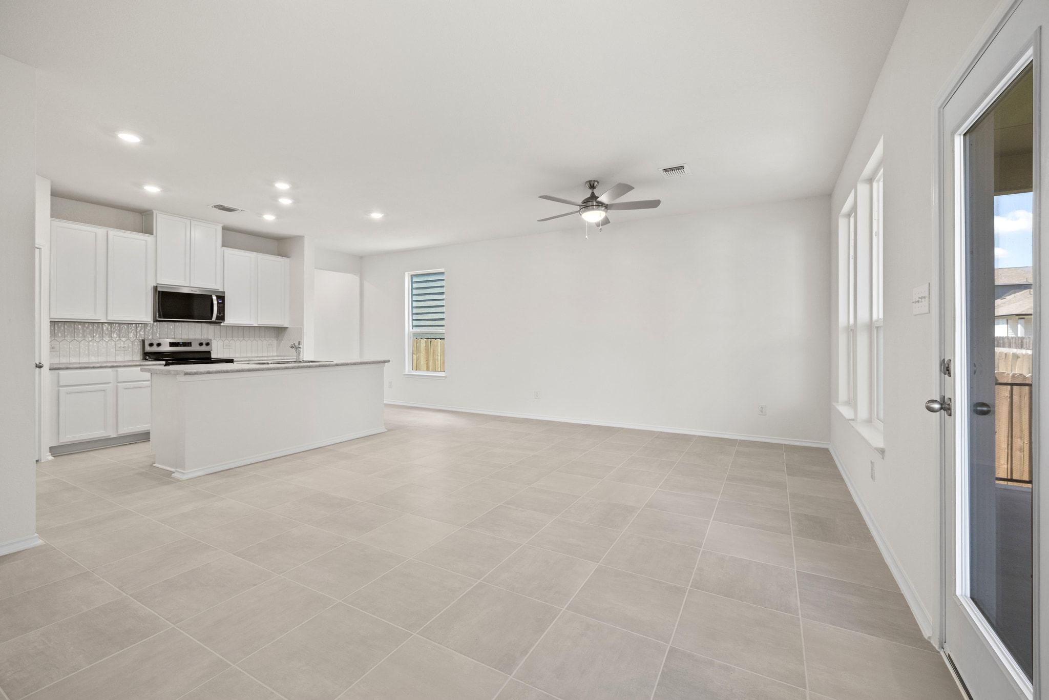 248 Feathers Street Jarrell, TX 76537 - Photo 6 of 32 a view of an empty room with kitchen and a window