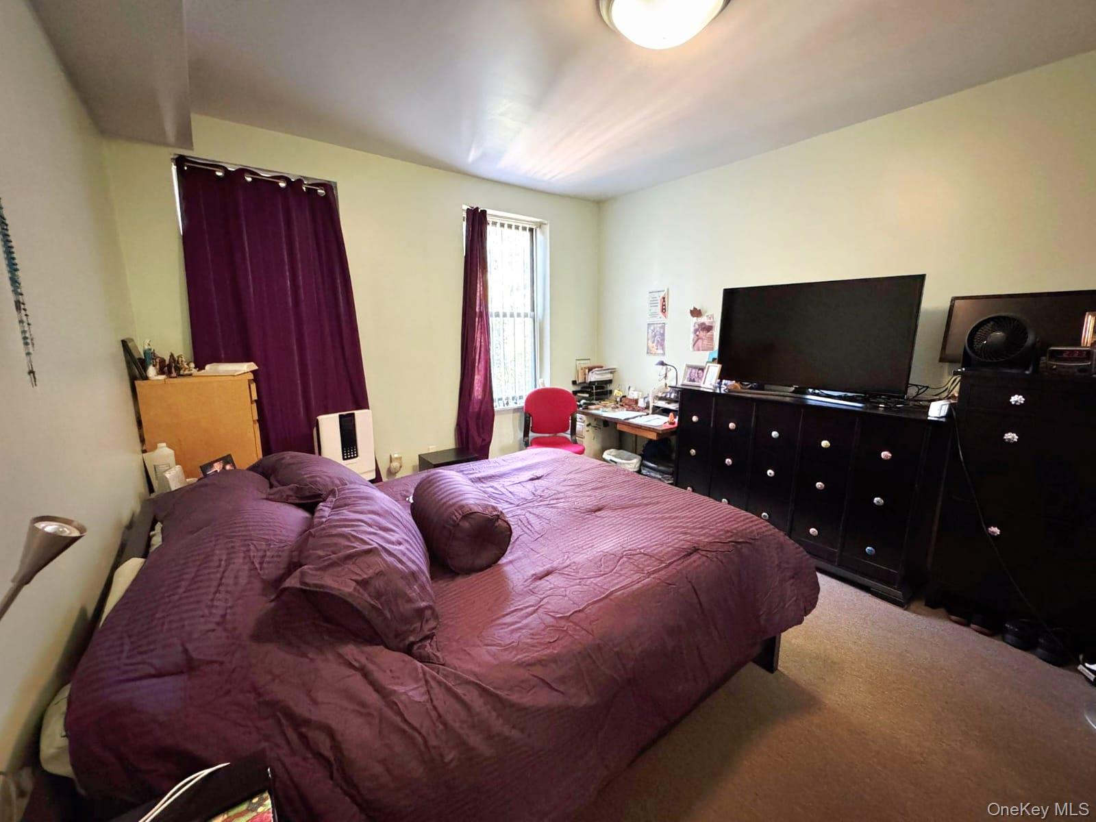 1231 Putnam Avenue Brooklyn, NY 11221 - Photo 17 of 20 a bedroom with a bed and a flat screen tv