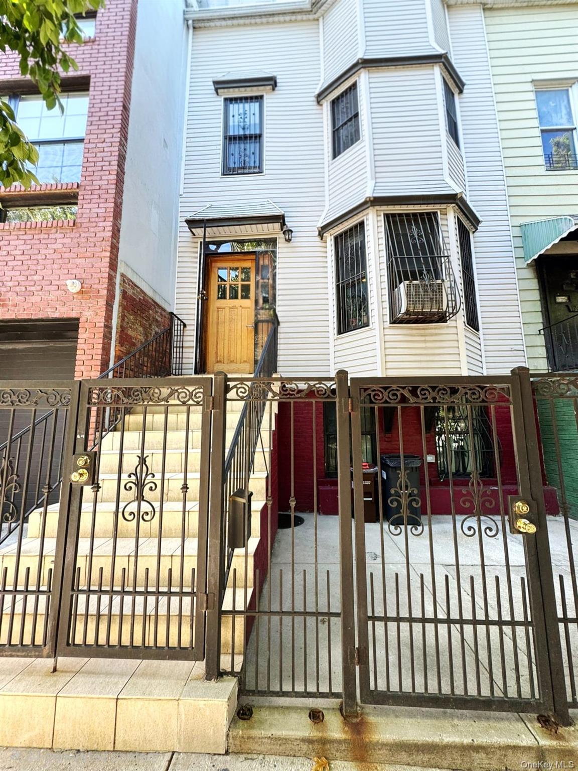 1231 Putnam Avenue Brooklyn, NY 11221 - Photo 3 of 20 a view of a house with wooden fence