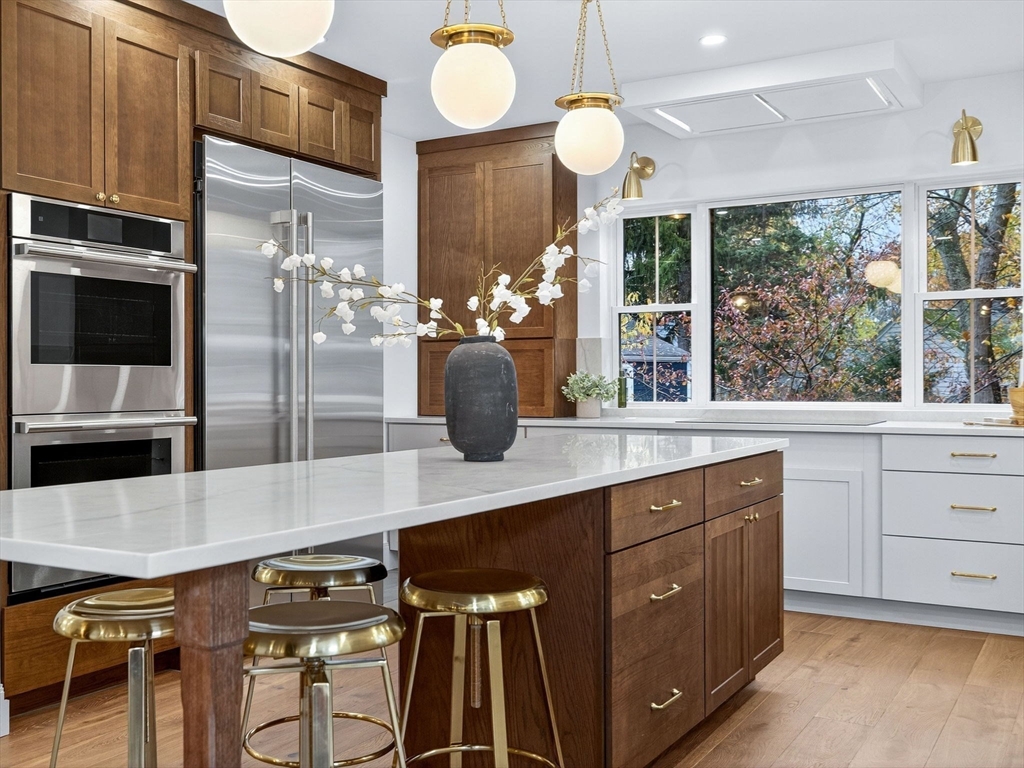 9 Norfolk Road Winchester, MA 01890 - Photo 15 of 42 a kitchen with stainless steel appliances a sink and a refrigerator