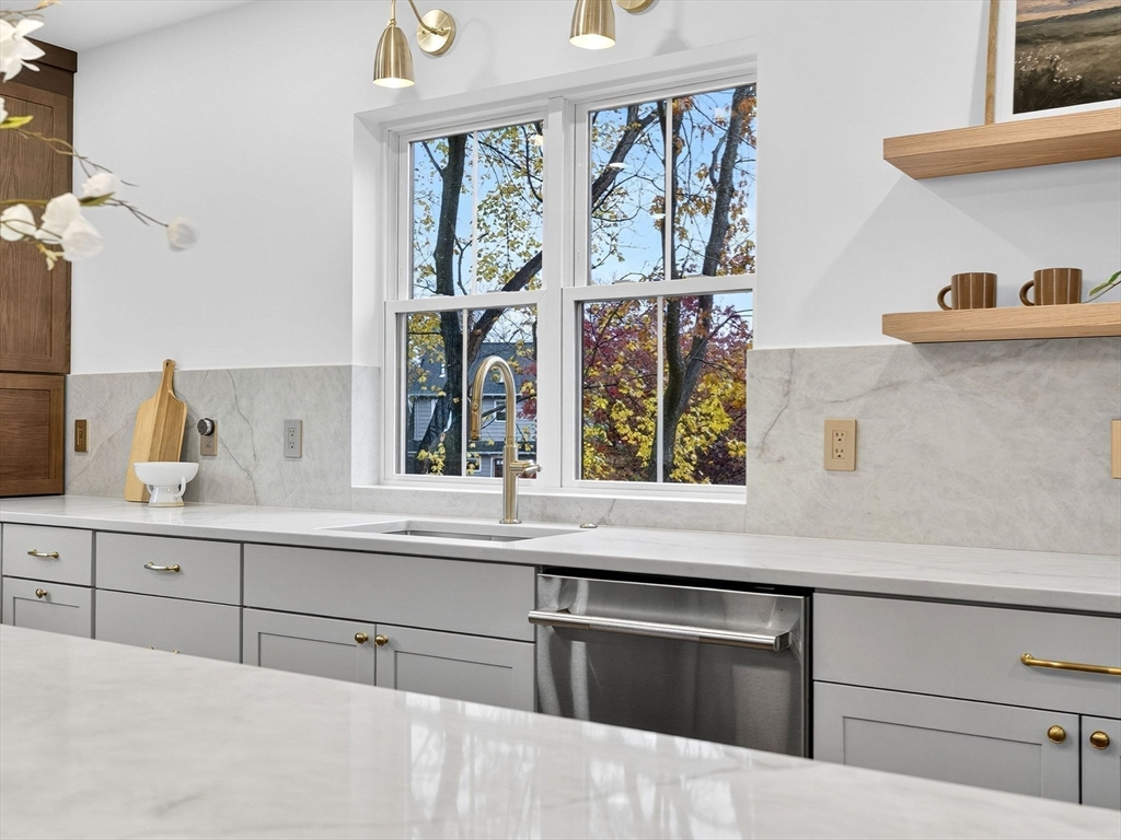 9 Norfolk Road Winchester, MA 01890 - Photo 18 of 42 a kitchen with stainless steel appliances white cabinets and a window