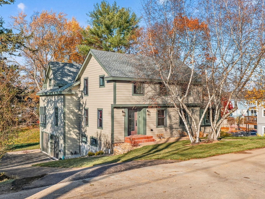 9 Norfolk Road Winchester, MA 01890 - Photo 2 of 42 a front view of a house with a yard garage and outdoor seating