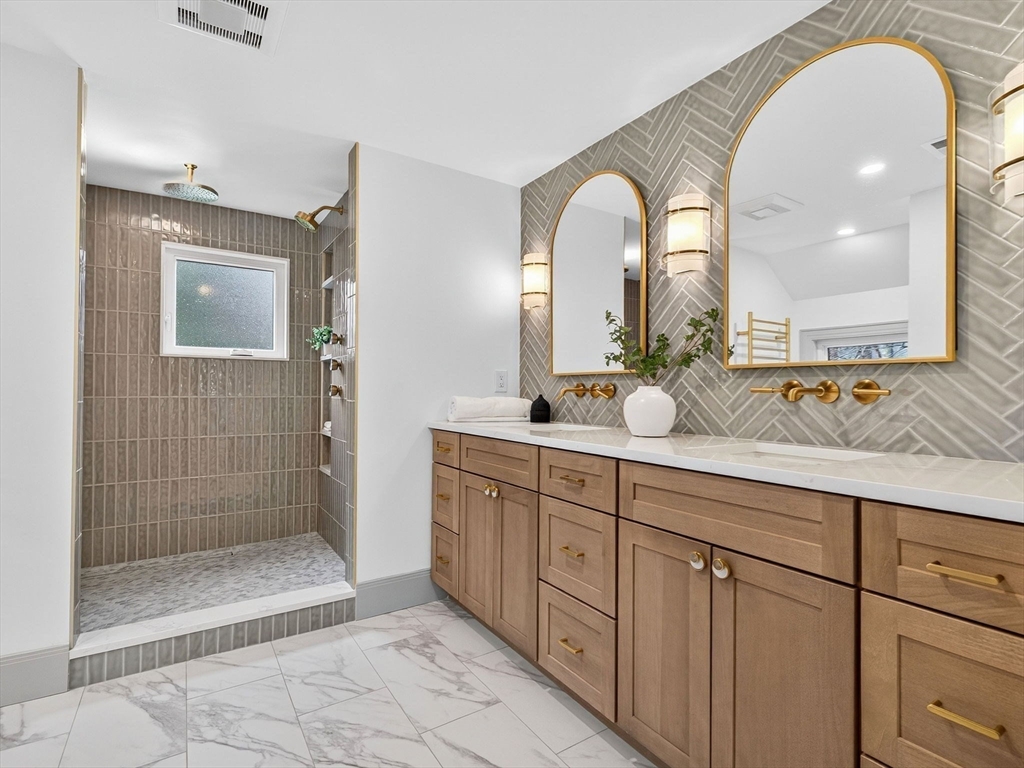 9 Norfolk Road Winchester, MA 01890 - Photo 25 of 42 a spacious bathroom with a mirror a shower and a sink