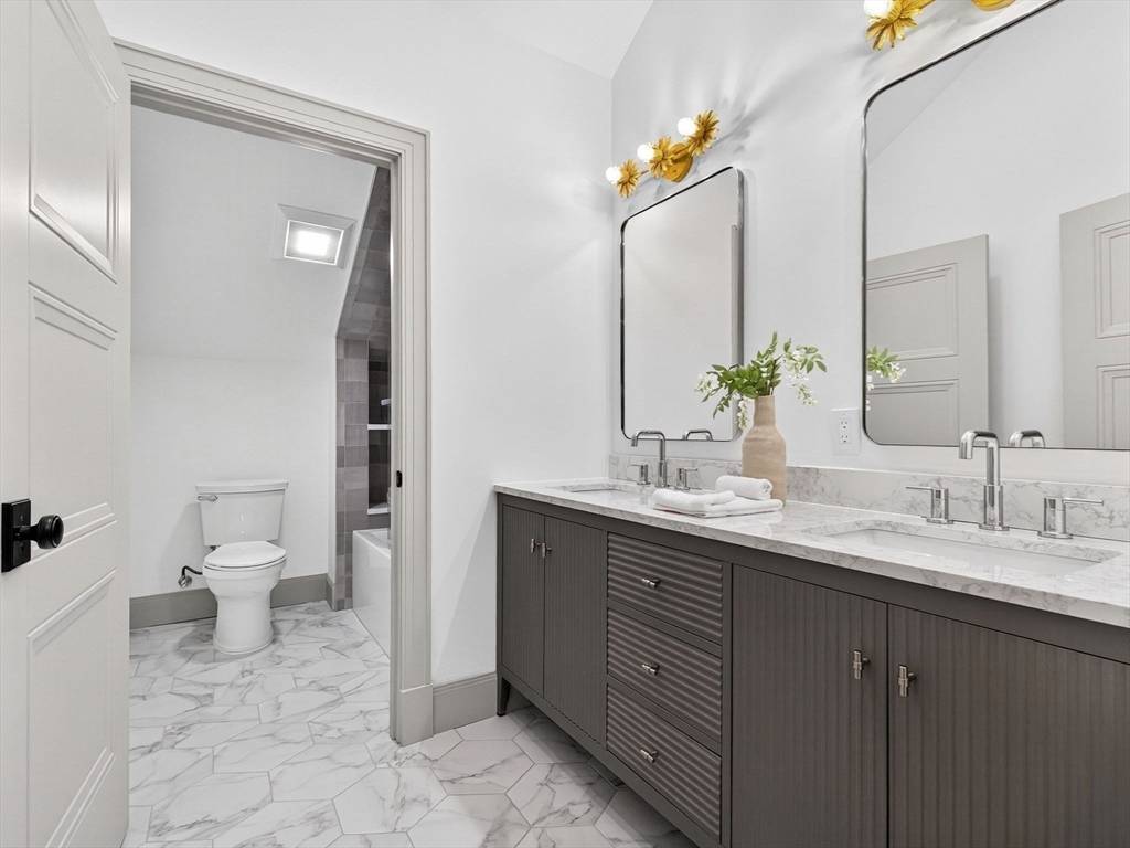 9 Norfolk Road Winchester, MA 01890 - Photo 33 of 42 a bathroom with a toilet sink and mirror