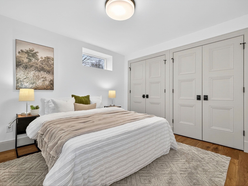 9 Norfolk Road Winchester, MA 01890 - Photo 37 of 42 a bedroom with a bed and a lamp