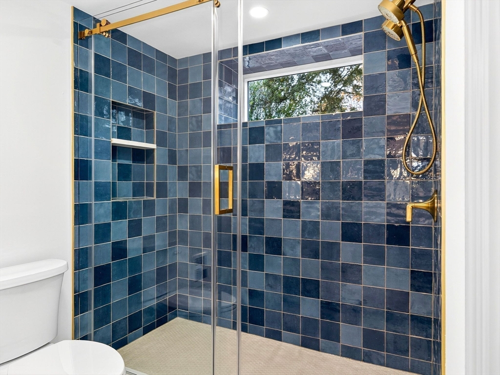 9 Norfolk Road Winchester, MA 01890 - Photo 40 of 42 a bathroom with a shower toilet and a sink