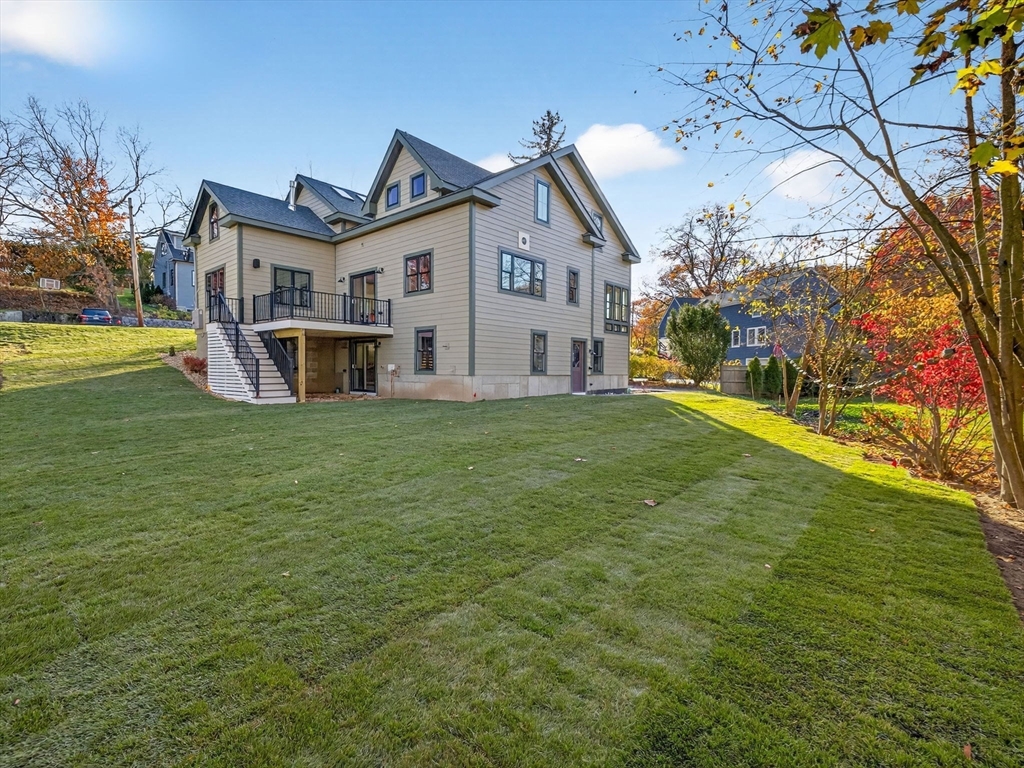 9 Norfolk Road Winchester, MA 01890 - Photo 5 of 42 a view of a white house with a big yard and large trees