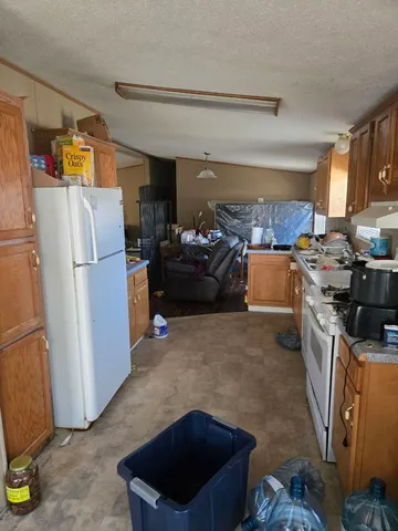 a kitchen with stainless steel appliances granite countertop a refrigerator stove and sink