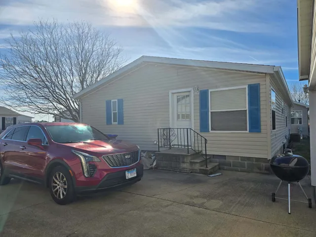 a front view of a house with parking space