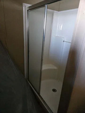 a bathroom with a glass door shower