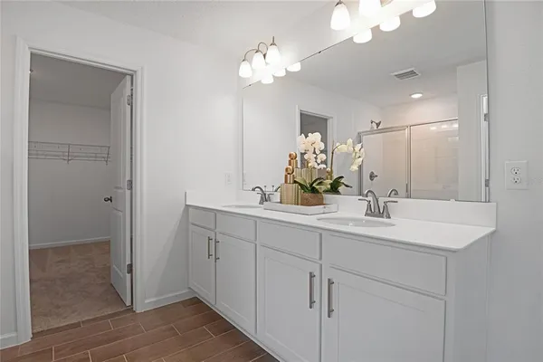 a bathroom with a sink double vanity and a mirror