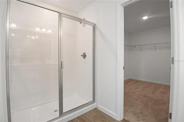 a bathroom with a glass shower door
