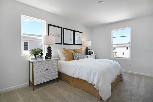 a bedroom with a bed potted plant and a window