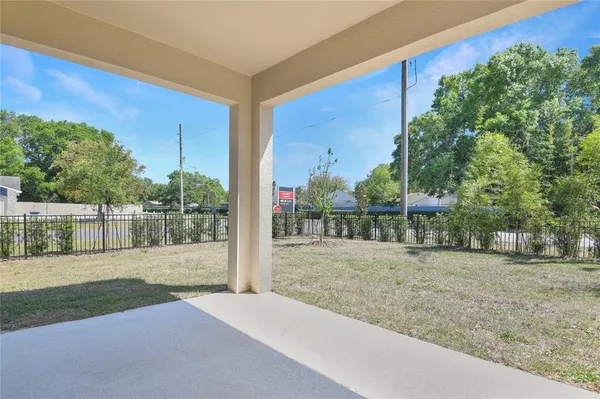 a view of a backyard with wooden fence