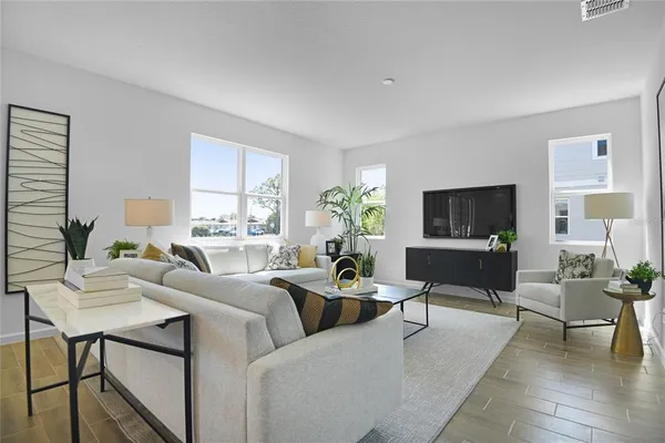 a living room with furniture potted plant a window and a fireplace
