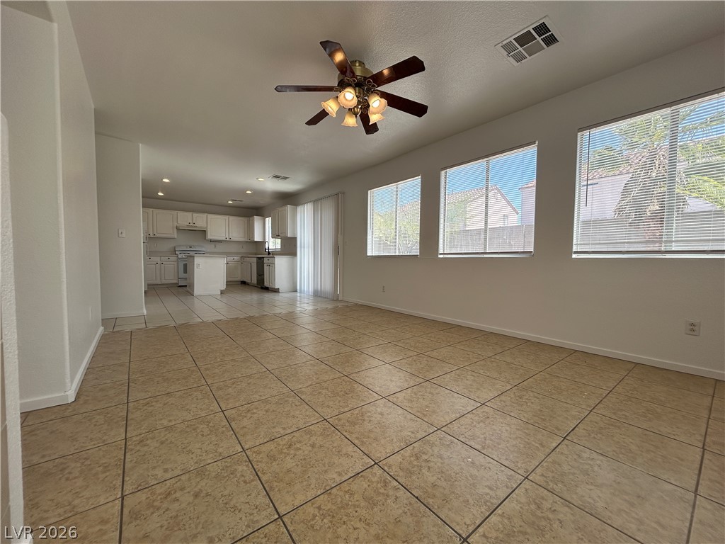 7373 Randel Jean Way Las Vegas, NV 89113 - Photo 5 of 14 An open layout connects the tile-floored living area to the adjacent kitchen space.