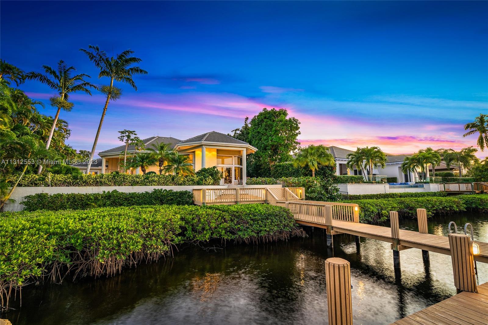 354 Eagle Drive Jupiter, FL 33477 - Photo 1 of 1 a view of a lake with a house in the background