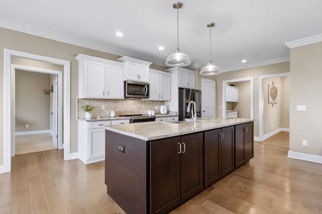 a kitchen with a refrigerator stove and sink