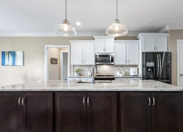 a dining room with kitchen island a table and chairs