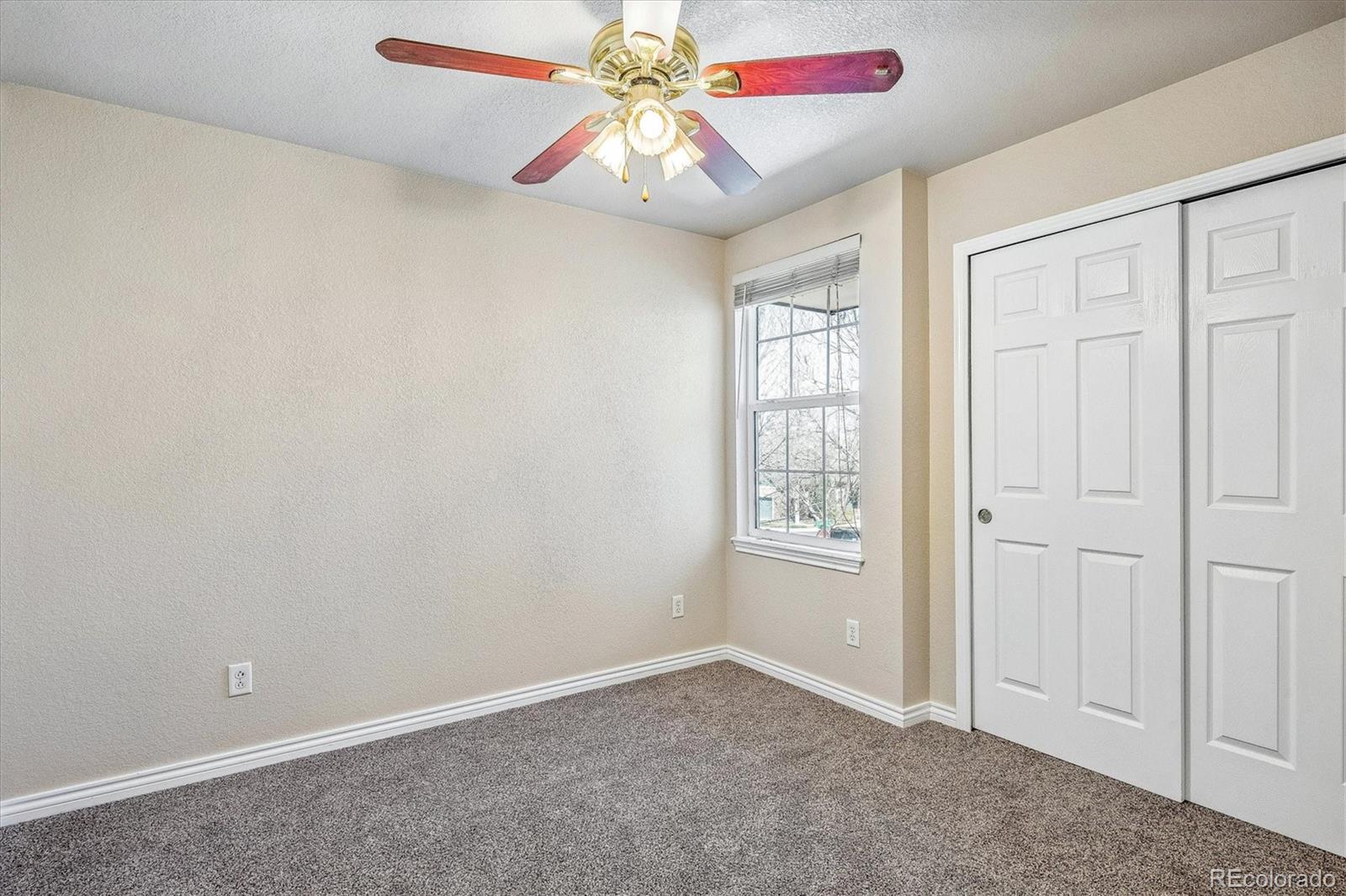 4545 South Taft Way Morrison, CO 80465 - Photo 21 of 24 an empty room with windows and chandelier fan