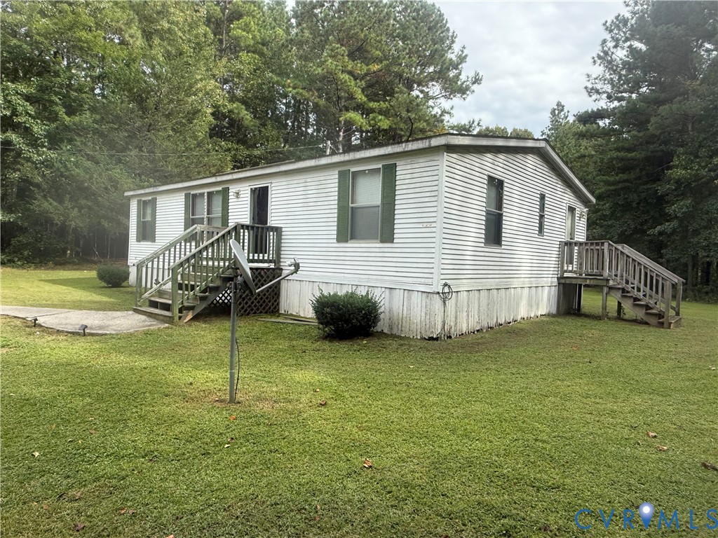 275 Doswell Road Blackstone, VA 23824 - Photo 3 of 9 a view of a house with a yard and deck