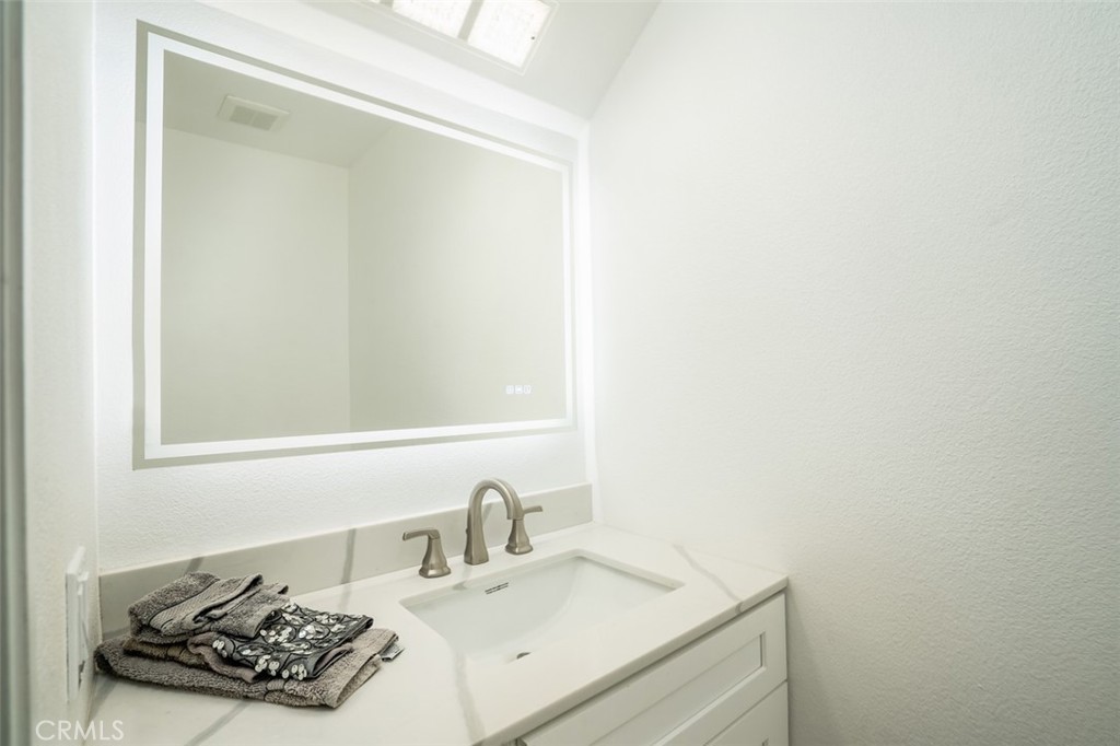 16734 Algonquin Street, Unit 6 Huntington Beach, CA 92649 - Photo 12 of 27 a bathroom with a sink and a vanity