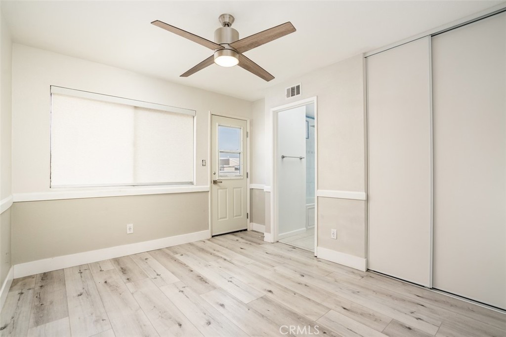 16734 Algonquin Street, Unit 6 Huntington Beach, CA 92649 - Photo 13 of 27 a view of a kitchen with wooden floor and a window
