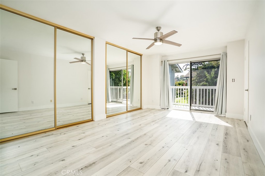 16734 Algonquin Street, Unit 6 Huntington Beach, CA 92649 - Photo 17 of 27 an empty room with wooden floor and windows