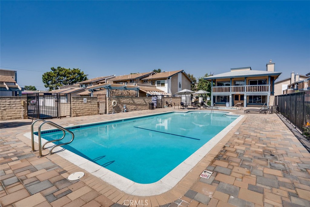 16734 Algonquin Street, Unit 6 Huntington Beach, CA 92649 - Photo 25 of 27 a view of a house with a swimming pool